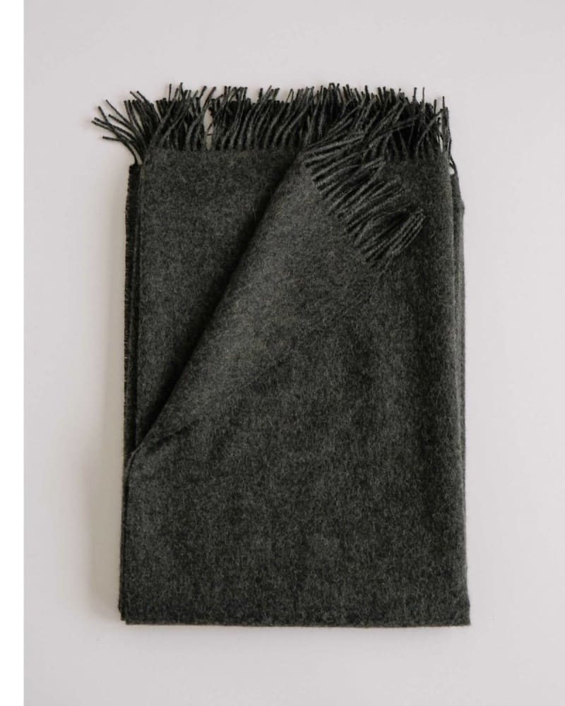 Front of a model wearing a size one-size-fits-all Alpaca Throw In Ledge in Ledge by Evangeline. | dia_product_style_image_id:360811